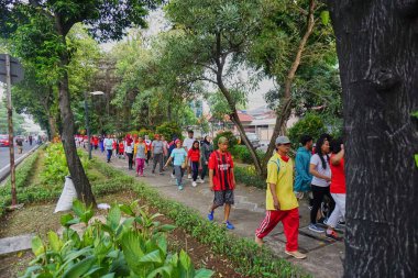 Jakarta, Indonesia - August 28, 2022: A group of people take part in a healthy walking competition and a leisurely walk to celebrate the 77th Independence Day of the Republic of Indonesia