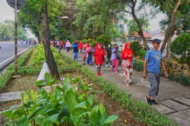 Jakarta, Indonesia - August 28, 2022: A group of people take part in a healthy walking competition and a leisurely walk to celebrate the 77th Independence Day of the Republic of Indonesia