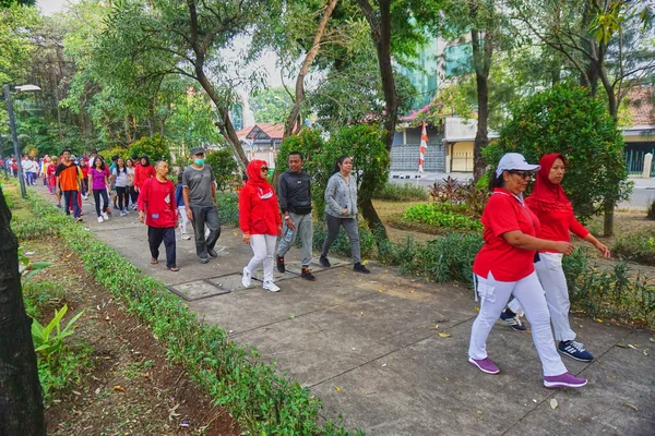 Jakarta, Indonesia - August 28, 2022: A group of people take part in a healthy walking competition to commemorate the 77th Indonesian Independence Day