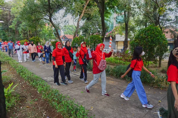 Jakarta, Indonesia - August 28, 2022: The spirit and joy of the participants of the healthy walking competition in celebration of the 77th Independence Day of the Republic of Indonesia