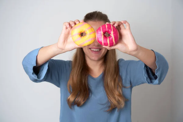 Portrait Happy Young Blonde Woman Showing Multicolored Donuts White Background — стоковое фото