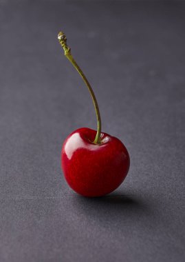 Sweet red cherry isolated on gray background, fresh cherry . Copy space. Food and fruit concept.