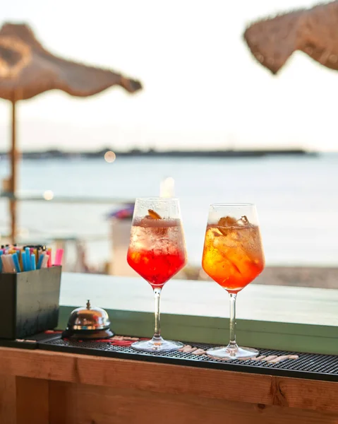 Spritz traditional cocktail with alcohol at a beach bar. European summer drink. Italian drink. Lifestyle concept
