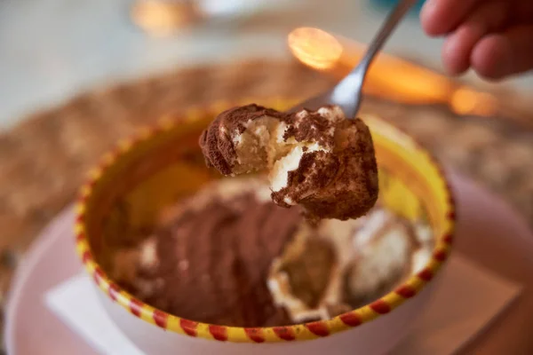 Traditional Italian dessert tiramisu in a dessert dish. Food concept