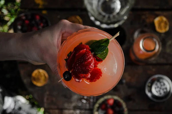 Fresh and tropical cocktail with strawberry and berries. Cold summer drink. Beverages and drink concept