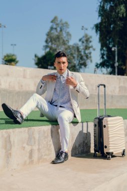 İki renkli kot pantolonlu, siyah beyaz kravatlı ve gözlüklü bir adam..