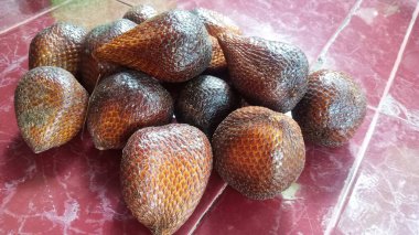 Salacca zalacca ya da Salacca edulis Endonezya tropik meyvesi denilen bir resmin yılan derisi gibi kahverengi bir teni vardır.