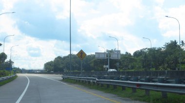 Katı beton yolun bulanık resmi berrak mavi gökyüzü ve biraz bulutlu.