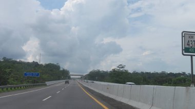 Katı beton yolun bulanık resmi berrak mavi gökyüzü ve biraz bulutlu.