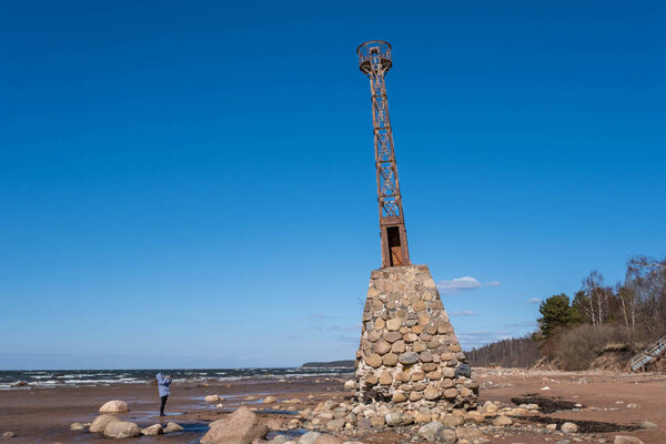 old ruins of Kurmrags Lighthouse on the shore of the Rigas Gulf, Baltic sea, Latvia.