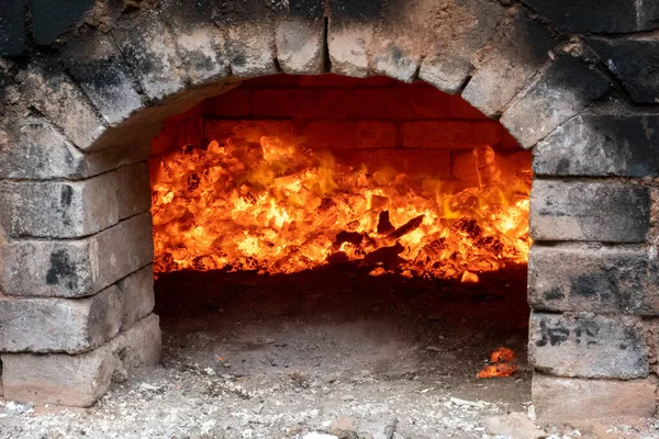 Firing of wood fire kiln is part of process for black pottery. Unique handmade pots and dishes of clay getting black after firing and oxygen reducing process in wood fire kiln. Latvian national crafts.