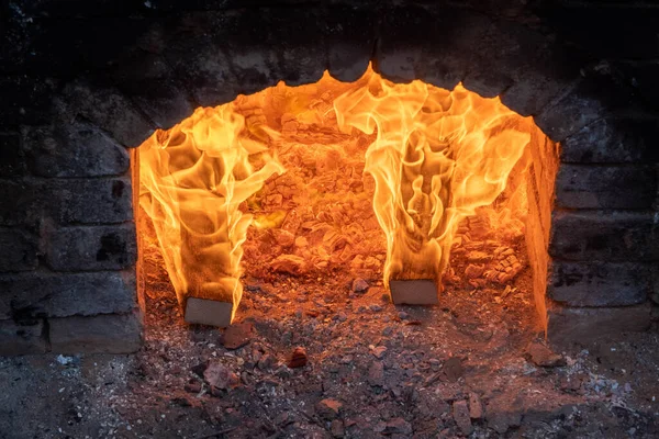 Firing of wood fire kiln is part of process for black pottery. Unique handmade pots and dishes of clay getting black after firing and oxygen reducing process in wood fire kiln. Latvian national crafts