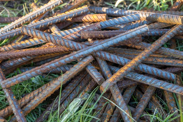 Metal fittings for reinforced concrete. Main construction materials. Background and rusty iron reinforcement rods. Red orange color of iron oxide on reinforcement bars.