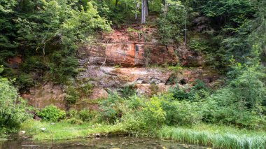 Mirror cliffs and an old river channel in a very beautiful forest in Cirulu nature trails, Latvia.