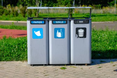 Waste sorting bins in Poland on the expressway. A rest stop on the side of the highway. Mixed, Plastic and metal, Paper, Glass.