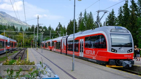 Strbske Pleso lake, Slovakia - August 19, 2022: red train in the Slovak Tatras in summer time.