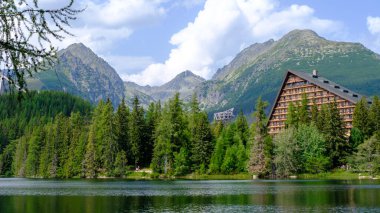 Strbske pleso. Misty horizons blue tones. High tatras mountains. Vysoke tatry. Autumn forest. Reflection in lake. Beautiful landscape. Slovakia. Hotel Patria