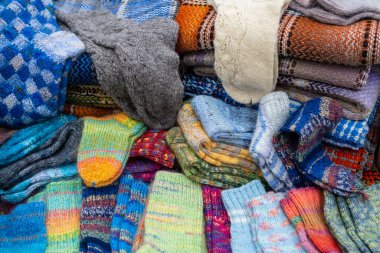 A Lot of various cotton socks and knitted woollen winter socks, top view. Handmade.
