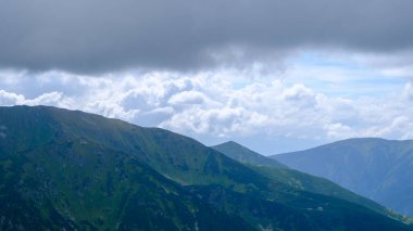 low hanging storm clouds and fog in the mountains on a summer day
