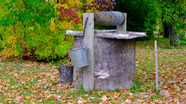 The old homestead well. Well, about water. The main source of water for agriculture. Sunny autumn day. Old retro looks traditional good