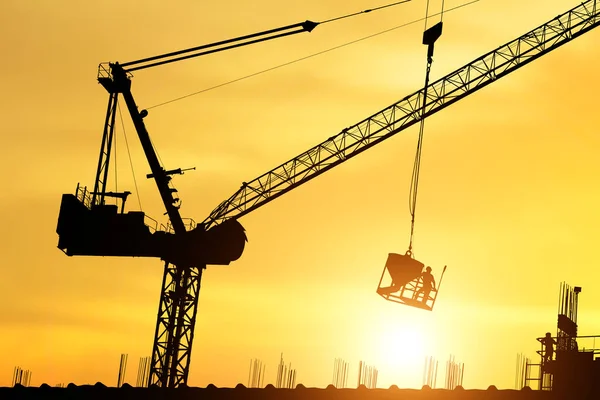 silhouette of workers working at a construction site, Construction workers work in preparation for binding rebar and concrete work.