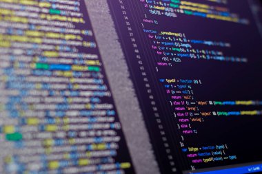 The software developer is doing php coding. Abstract code background. Selective focus code on computer screen