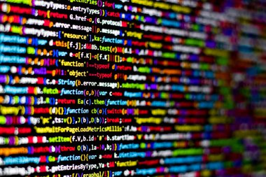 Colorful code background. compressed javascript code on computer screen. Software developer coding screen