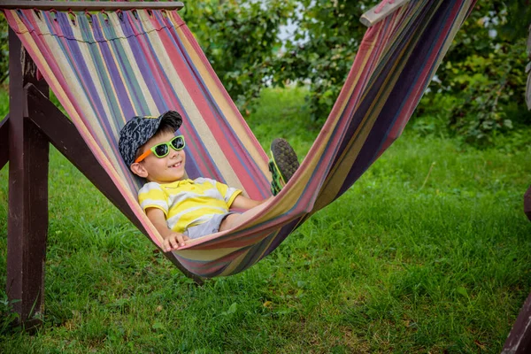 Милый Маленький Кавказский Мальчик Расслабляется Веселится Разноцветном Гамаке Заднем Дворе — стоковое фото