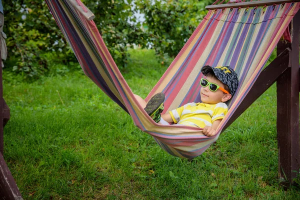 Милый Маленький Кавказский Мальчик Расслабляется Веселится Разноцветном Гамаке Заднем Дворе — стоковое фото