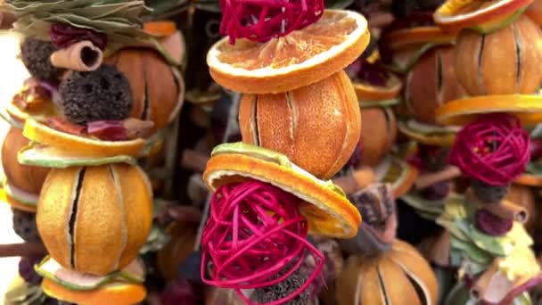 Ароматные приправы на прилавке ярмарки на нитке висят различные сухофрукты и овощи красно-желтого цвета, излучающие приятный запах — стоковое видео