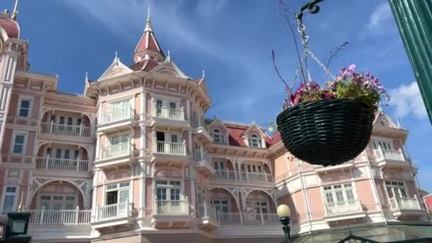 Vstup do růžového hotelu Disneyland Castle s hodinami 11.04.22 Disneyland Paris Francie — Stock video