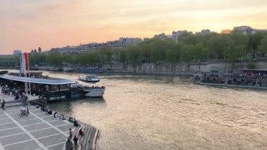 Paris, Fransa Eyfel Kulesi 'nin manzarası ve denizde bir tekne. Beaugrenelle turist bölgesi. Metal bir köprüde üstten metro geçiyor. Seine nehrinin üzerinde gün doğumu.