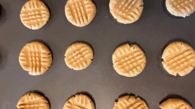 the camera slowly floats up, looking at cookies on baking sheet as if they were laying out They are still raw, they will now be put in oven for cookies they very appetizing crumbly shortbread dough
