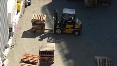 Small construction machine for carrying wooden blocks presentation from place to place in video you can see how it transfers and transfers them by folding them into one pile. High quality 4k footage