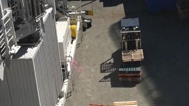 Small construction machine for carrying wooden blocks presentation from place to place in video you can see how it transfers and transfers them by folding them into one pile. High quality 4k footage