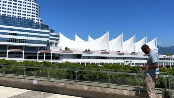 American Man Stands Background Canada Place White Sails Looks Phone — Vídeo de stock