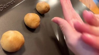 in your hands, swing a circle of dough for making cookies and put it on the protven. High quality 4k footage