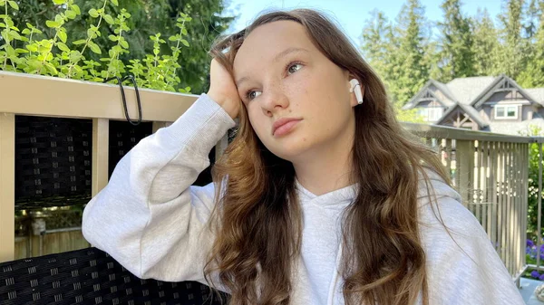 Teenage Girl Gray Sweatshirt Sits Propping Her Head Her Hand — стоковое фото