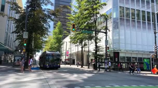 Bus Blue Yellow Passes Camera Street People Further Street Vancouver — Video Stock
