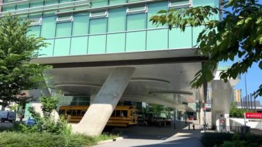 University of British Columbia the main building in front of the entrance is a school bus sees glass blue windows from afar and no one is around Vancouver Canada 07.2022. High quality 4k footage