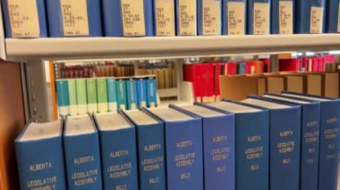 Library Law of the University of British Columbia The camera slowly moving shows all the books that are on the shelves of different colors of different sizes for the law Canada Vancouver 07 2022.