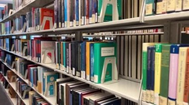 Library Law of the University of British Columbia The camera slowly moving shows all the books that are on the shelves of different colors of different sizes for the law Canada Vancouver 07 2022.