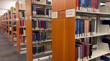 Library Law of the University of British Columbia The camera slowly moving shows all the books that are on the shelves of different colors of different sizes for the law Canada Vancouver 07 2022.