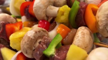 delicious kebab with lots of vegetables chicken and pork fried on a barbecue on the grill turn over and smear with sauce it has pepper onion mushrooms pineapple pineapple kebab is a food orgasm