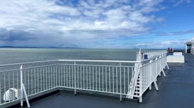 The upper deck of the ferry departing from Canada to Vancouver Island is a clean white deck with a blue flag white stripes on a blue background This is the flag of the ferry everywhere sea-ocean.
