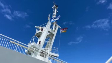 The upper deck of the ferry departing from Canada to Vancouver Island is a clean white deck with a blue flag white stripes on a blue background This is the flag of the ferry everywhere sea-ocean.