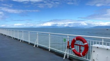 the deck of the ship is visible Only the white bridge and the red rescue circle as well as the sky The Pacific Ocean restless water on the sea Calm relax travel travel agency that will always save.