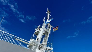 The upper deck of the ferry departing from Canada to Vancouver Island is a clean white deck with a blue flag white stripes on a blue background This is the flag of the ferry everywhere sea-ocean.