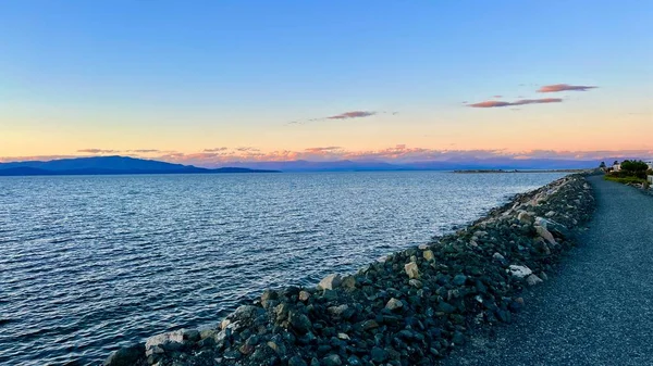 complete calm no wind no waves on pacific ocean looks like a lake on Vancouver island blue water silence calm tranquility and peace great place to relax background Parksville beach Surfside RV resort