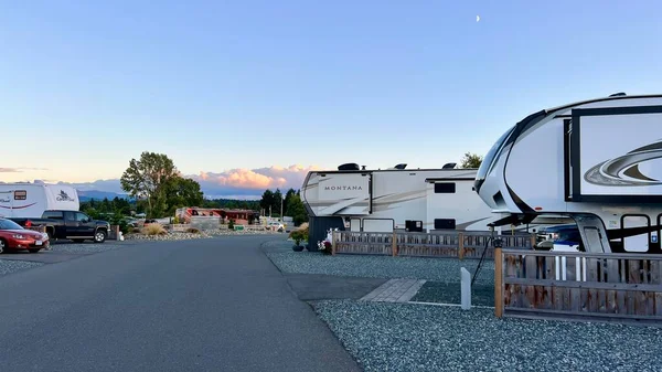 Parksville beach Surfside RV resort camping in trailers on the shores of the Pacific Ocean several trailers stand in a row next to them cars Montana trailer
